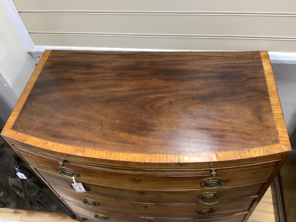 A Regency mahogany satinwood banded bow-fronted chest, fitted brushing slide and four drawers on swept bracket feet, width 92cm depth 51cm height 90cm